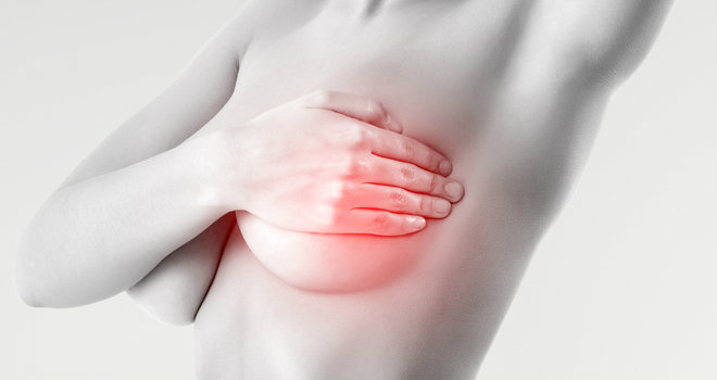 woman examining breast mastopathy or cancer